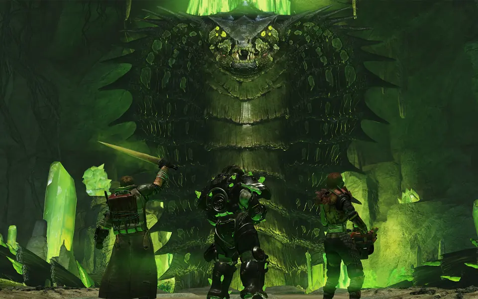 Players fighting among glowing green crystals underground